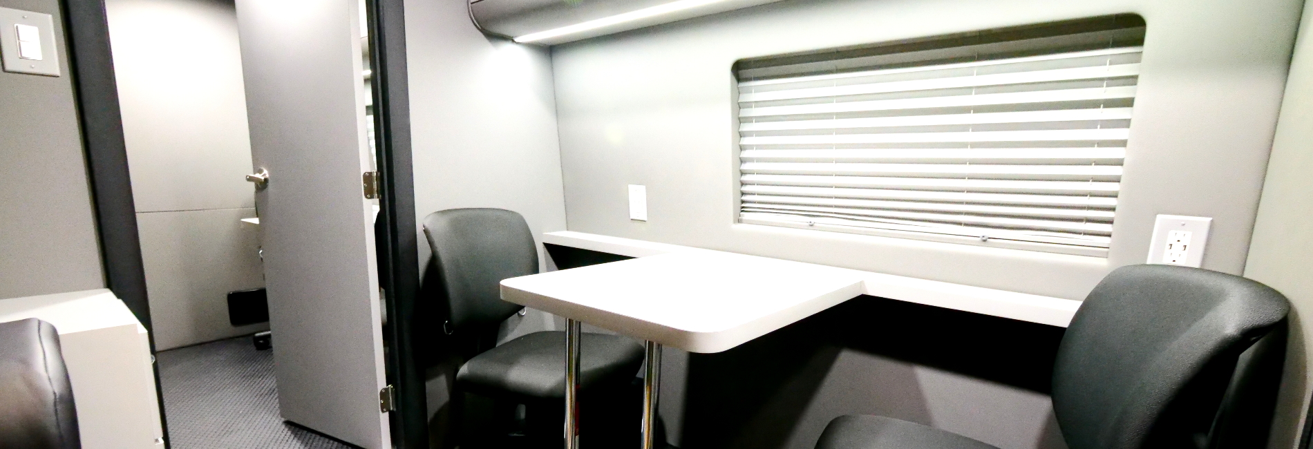 Dual configuration mobile office featuring a partition door, workstations desks, storage cabinets, and much more!