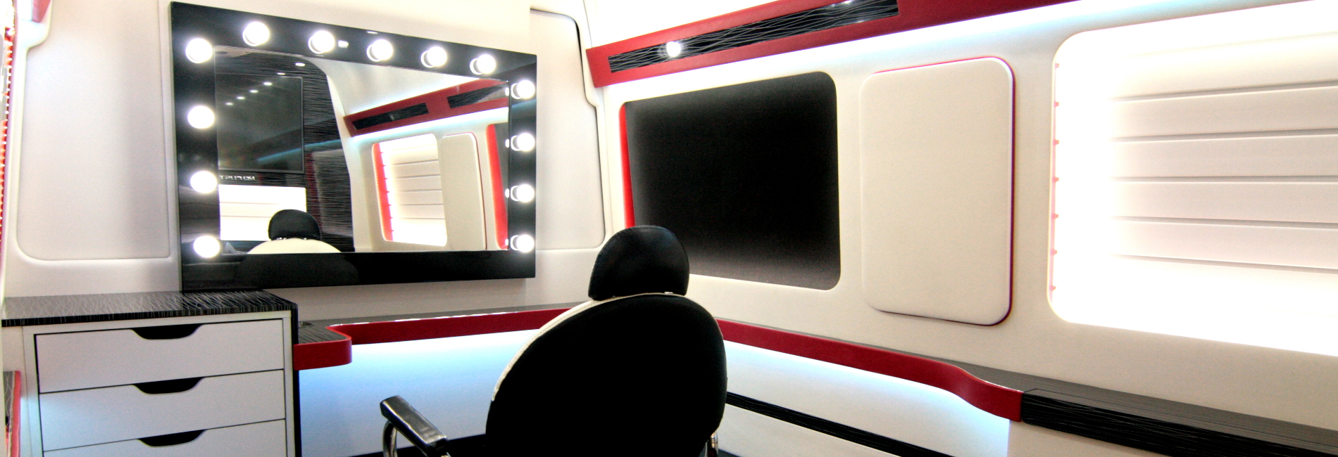 A mobile hair salon that features an opulent and spacious interior with amenities set up for clients.