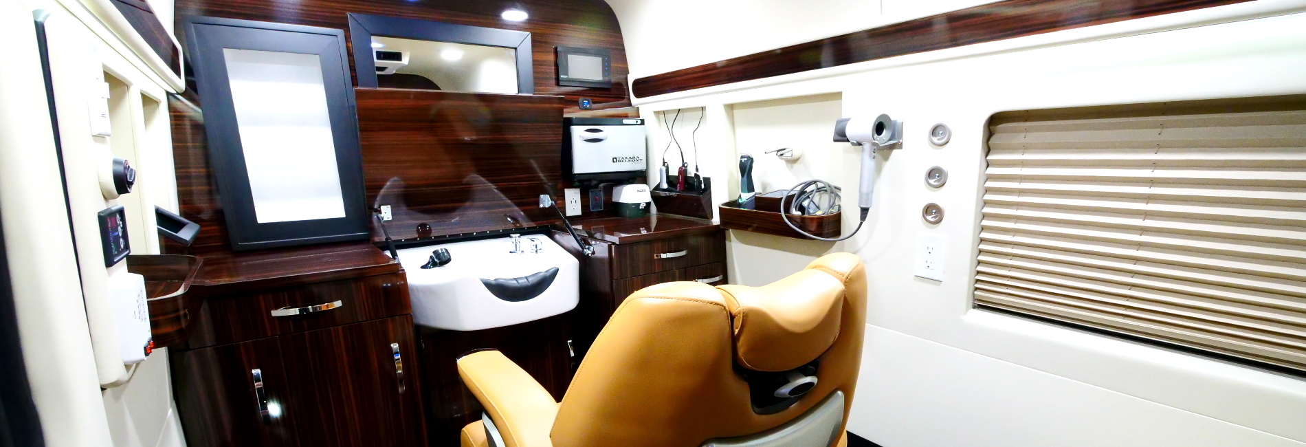 Fully realized mobile barbershop with a barber chair, full workstation, hot/cold water, built-in vacuum, and more!