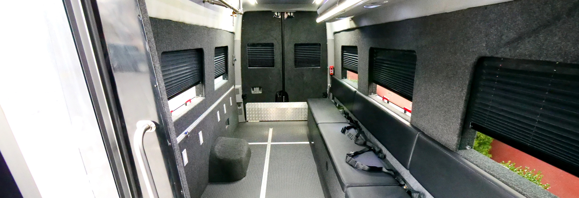 Mobile movie production chase van with film crew bench seating, hanging monitor brackets, rear lift, and storage for equipment.